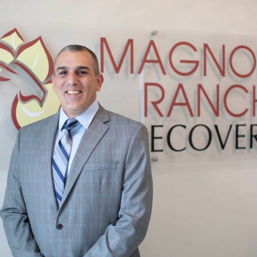 IMG_0570PS_pp Peter in front of the Magnolia Ranch Recovery plaque